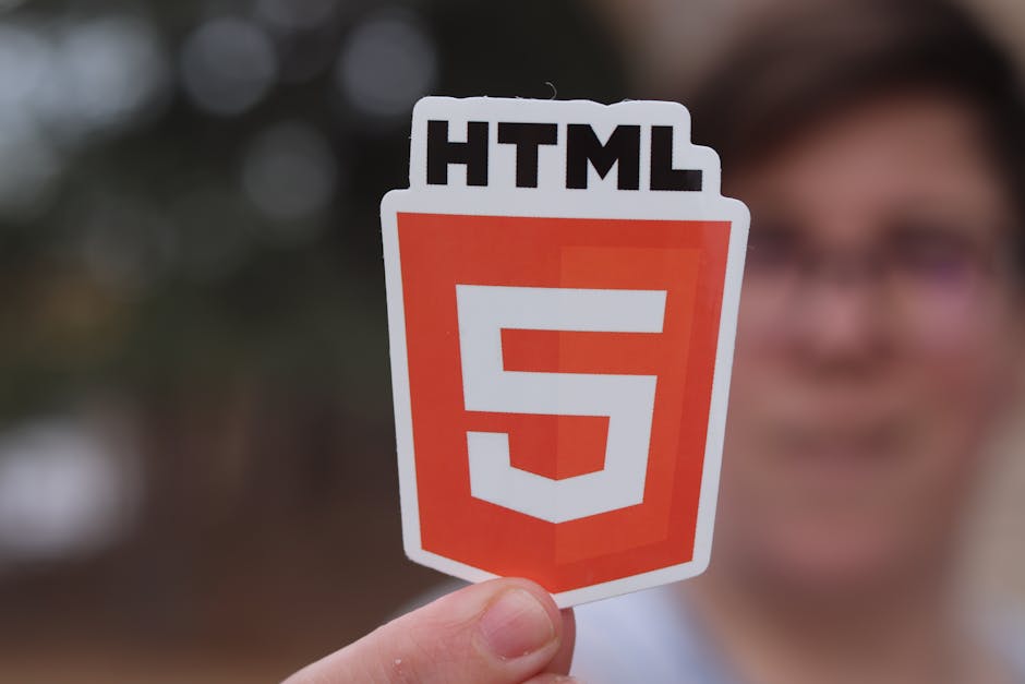 The image displays a close-up view of a computer screen with lines of code in various colors, including blue, yellow, orange, and red, set against a dark background. The code appears to be JavaScript